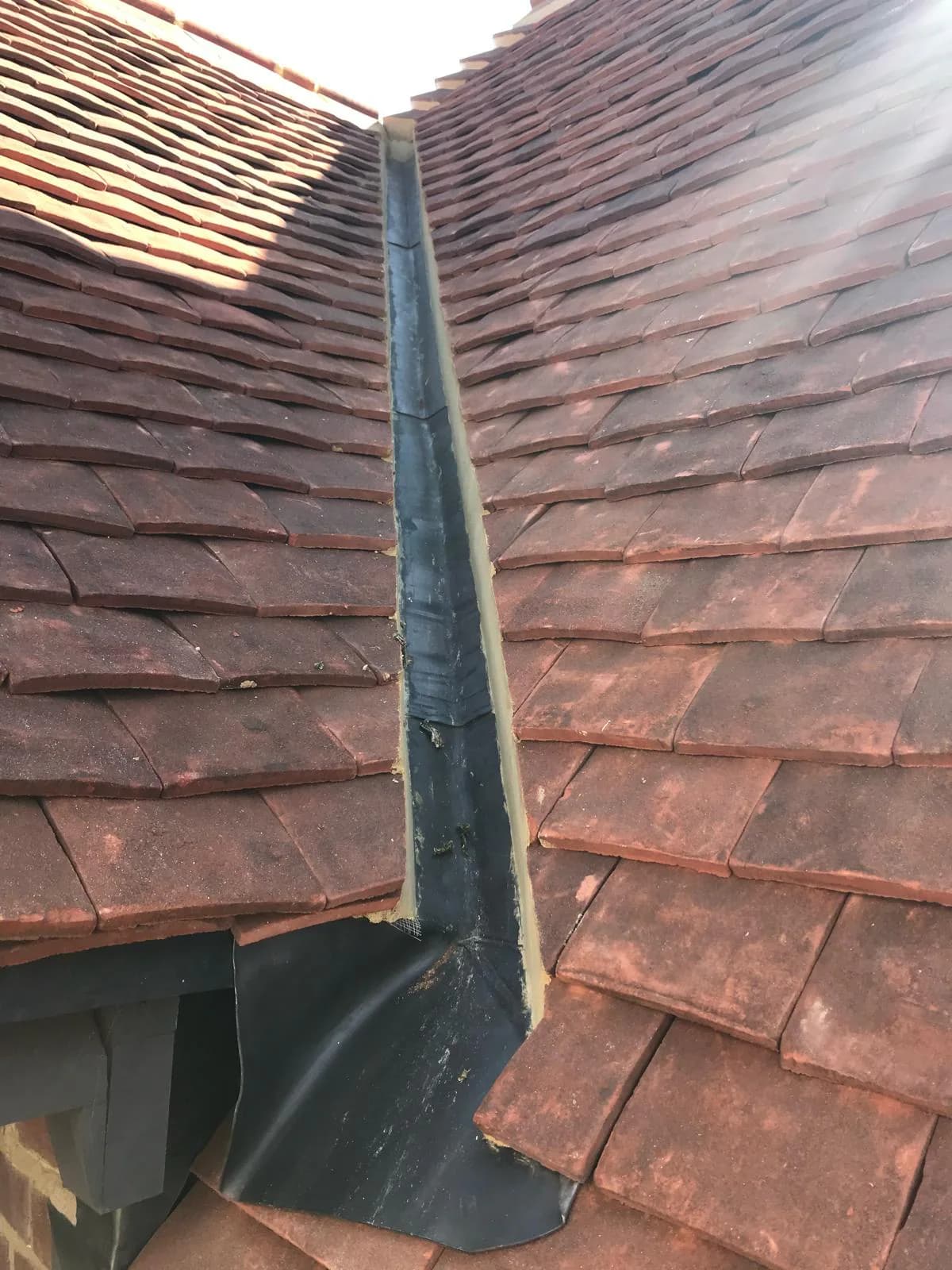 Completed roof tiling on a village home in Stock
